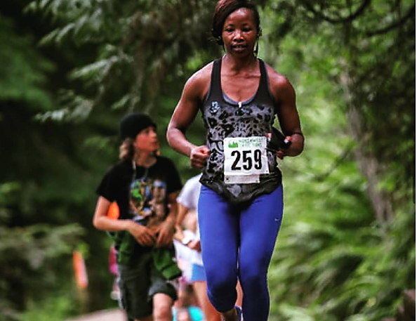 Running a half marathon with other runners on the path behind